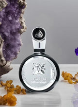 Eau de parfum bottle with black cap and silver circular label on display