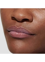 Muted rose-pink tinted lips with glossy sheen