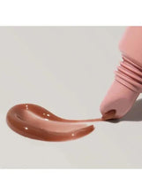 Sheer light brown lip tint swatch with glossy, gel finish