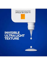 Sunscreen bottle dispensing a small clear drop of invisible fluid