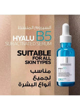 Serum dropper bottle with blue liquid in transparent vial and white cap