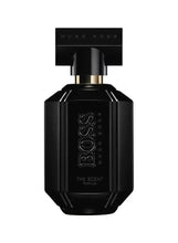 Front view of black parfum bottle with gold spray cap and embossed lettering