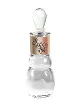 Clear glass perfume oil bottle with gold-toned label and faceted top, 60 ml