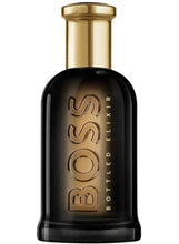 Intense men’s fragrance bottle, black glass with gold cap and Boss Bottled text