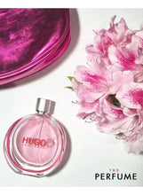 Angled HUGO Extreme eau de parfum bottle with pink liquid and silver cap