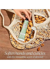 Almond hand and nail care bottle with green label, in a mesh bag with almonds