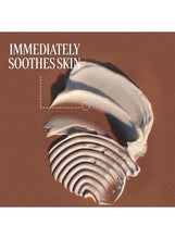 Hand cream being spread on skin, pale cream with circular swirl texture