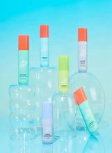 Mini trial skincare set with multiple pastel bottles and a clear pouch base