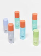 Mini trial skincare bottles set with pastel tubes and orange-topped caps
