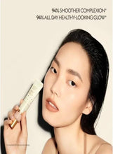 Gucci Glow skin tint held by model, light beige tube for Fair Medium shade