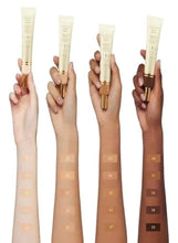 Multiple Gucci Glow skin tint tubes showing shade differences on hands