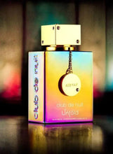Armaf eau de parfum bottle with gold cap and pendant tag, colorful glass