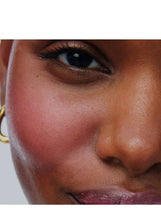 Close-up cheek with rosy pink blush and matching rosy lip