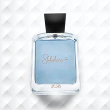 Eau de parfum bottle with dark cap and gold logo on clear blue-tinted glass