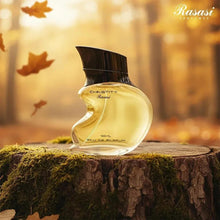 Rasasi Chastity 100ml eau de parfum bottle, gold glass with black cap on stand