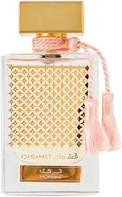 Eau de parfum bottle with gold cap, white patterned label and pink tassel