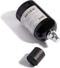 Men's eau de parfum bottle with barcode label on black glass, black cap