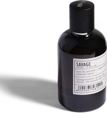 Men's eau de parfum bottle in black glass with label and black cap, 100 ml