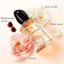 Eau de parfum bottle with black cap and floral accents around it