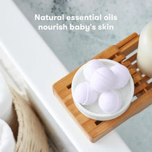 White bath bomb spheres in a bowl with soft lavender petals