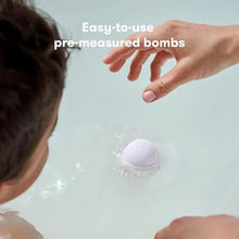 Lavender bath bomb dissolving in baby bath water with bubbles