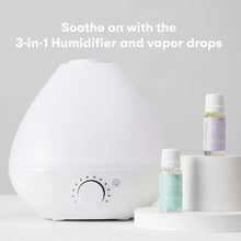 White 3-in-1 humidifier with vapor drops bottles on a table