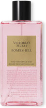 Bombshell fragrance mist bottle with black cap; pink clear glass and front label