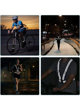 Reflective safety jacket with white stripe trim on dark fabric, worn by cyclist