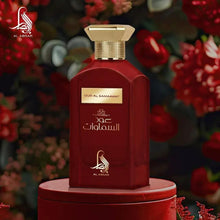 Eau de parfum bottle in dark red with gold cap, on a round base