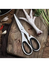 Stainless steel kitchen scissors with oval finger holes and scalloped lower blade