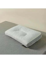Quilted latex pillow with cutout top and gray base sides, white cover.