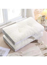 Quilted latex pillow with cutout top and gray side base, white cover.