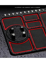 Black anti-slip mat with red trim, textured surface, and phone holder slots