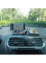 Blue and black anti-slip dashboard mat with phone and accessory slots on dashboard