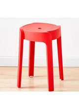 Red plastic round stool standing on four straight legs with circular seat hole