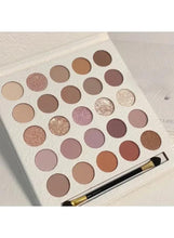 Cream eyeshadow palette with 25 matte and shimmer shades, open with brush