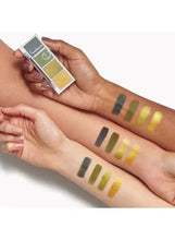 Eyeshadow swatches on forearms in gold and green tones