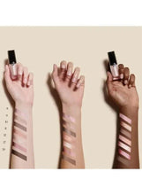 Bronze-brown shimmer eyeshadow swatches on hands, wand-applied lines