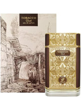 Eau de parfum bottle with gold geometric design, clear base, and box behind