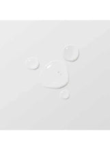 Clear serum dots and drips on a light surface