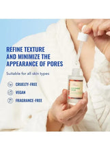 Niacinamide serum bottle with dropper in hand on white fabric