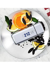 Fragrance bottle on plate with orange and lemon slices plus dark spice pods