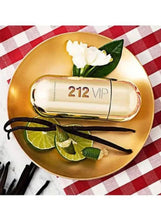 Carolina Herrera 212 VIP perfume bottle on gold plate with lime and flower
