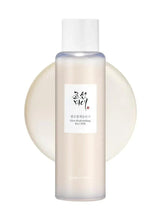 Rice facial sebum toner bottle with white cap and translucent light-brown liquid