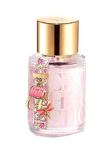 Pink perfume bottle with ornate CH label and gold cap