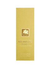 Perfume box back with floral emblem and small text on pale yellow
