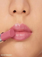 Soft pink glossy lipstick on lips with a smooth shine finish