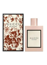 Gucci Bloom box and pink perfume bottle side by side
