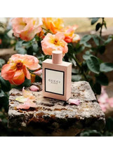 Gucci Bloom perfume bottle with square front label and pink cap on stone