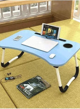 Blue laptop desk on carpet with foldable legs and tablet stand